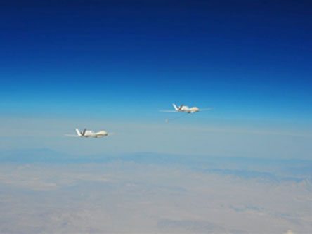 2 Global Hawk Unmanned Aircraft Fly in Close Formation